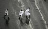 Muslim pilgrims run for cover as heavy rain streams down a road in the holy city of Mecca