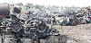 People look wreckages of burnt NATO trucks that  were destroyed in armed attack